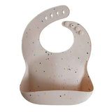 Mushie® Silikonový bryndák Vanilla Confetti