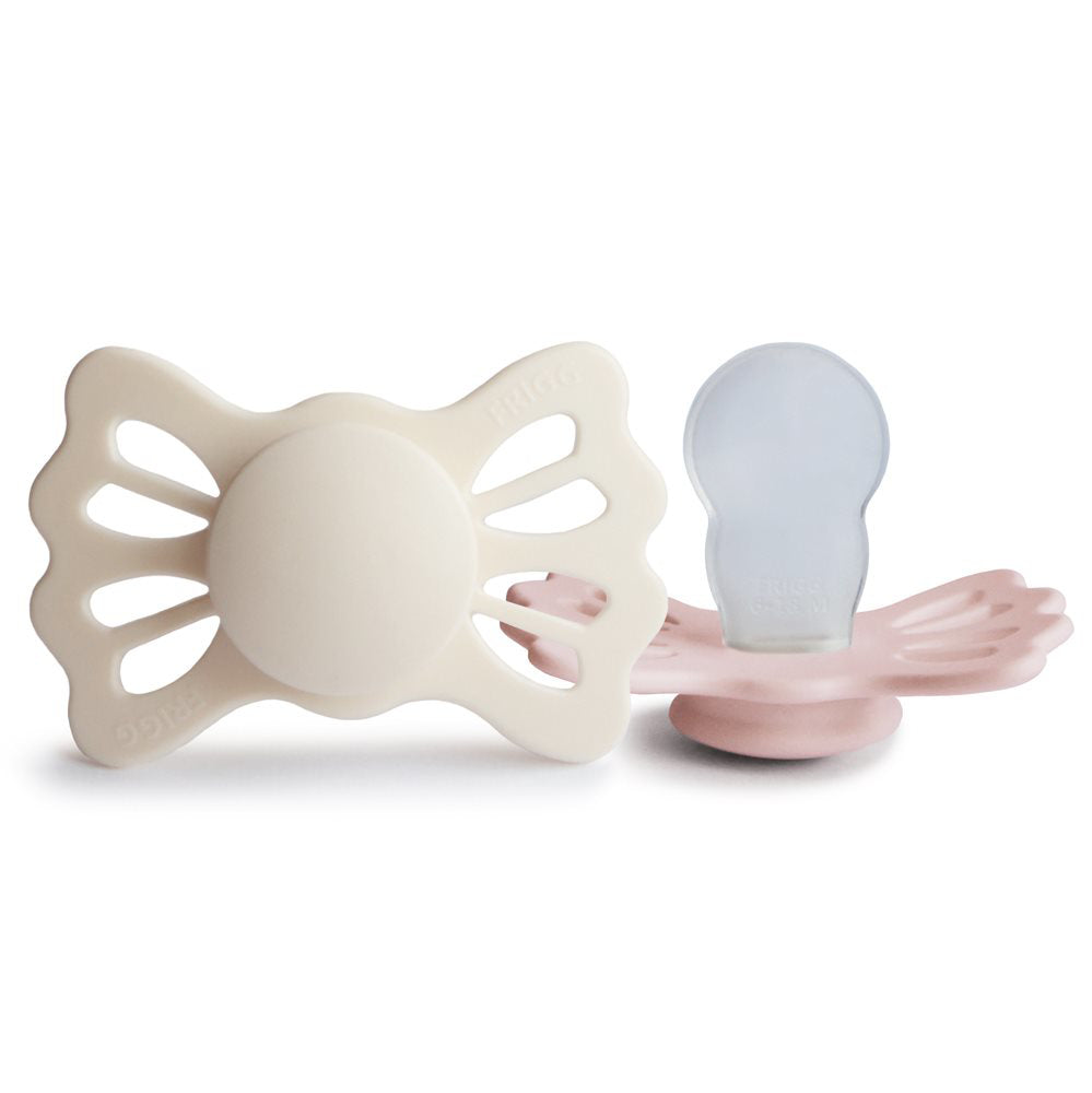 Frigg® Simetrična Duda iz silikona Lucky Cream/Blush 6-18 M FRIGG